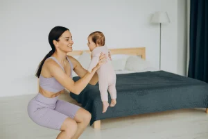Mother with her baby daughter doing body sculpting at home